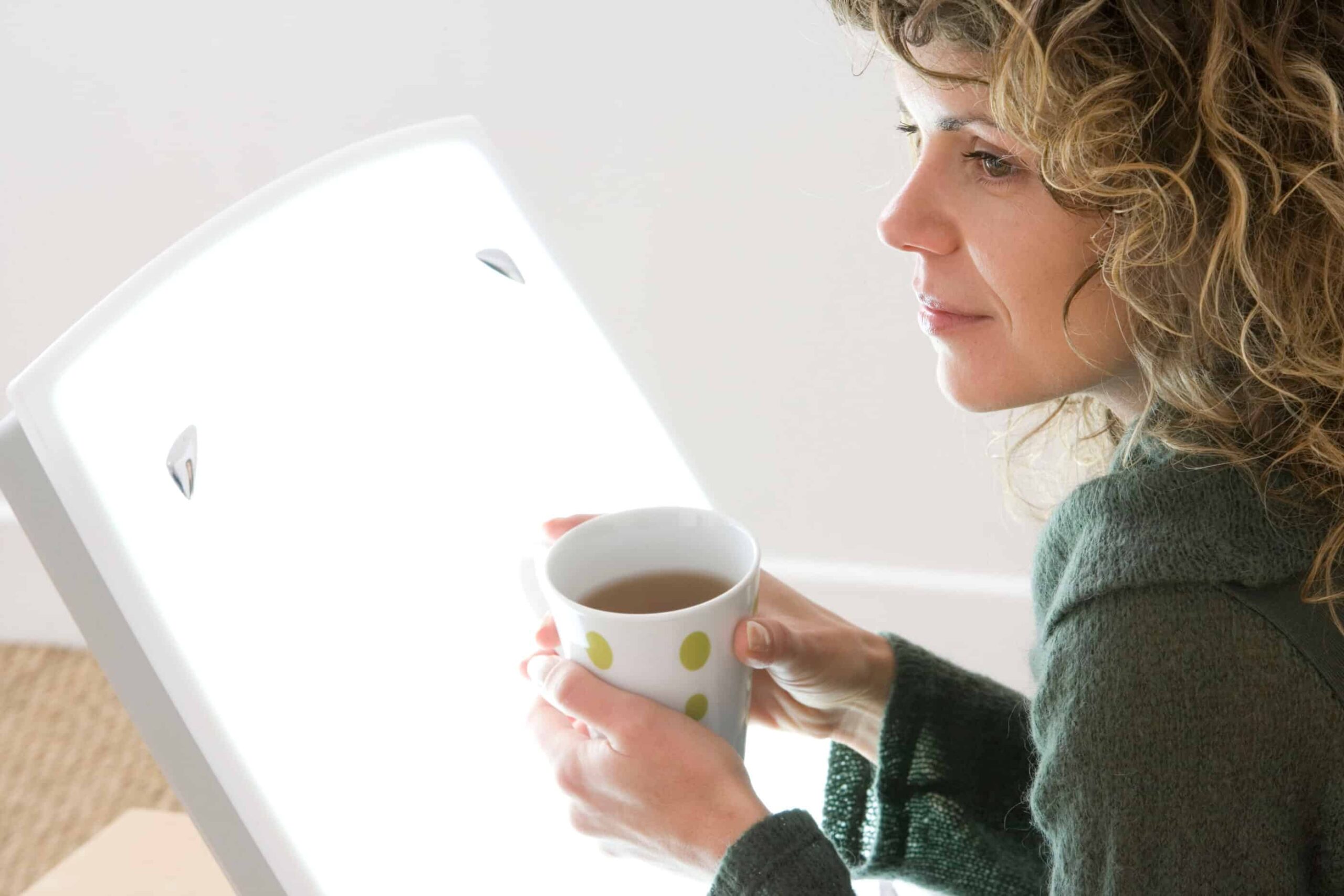 Woman treating her seasonal affective disorder through this light therapy